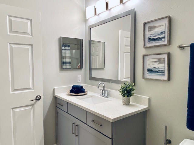 a bathroom with a sink and a mirror at Mainstreet Apartments, Clearwater, FL, 33756